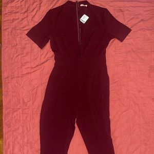 Burgundy romper with the deep split in the middle chest area straight leg
